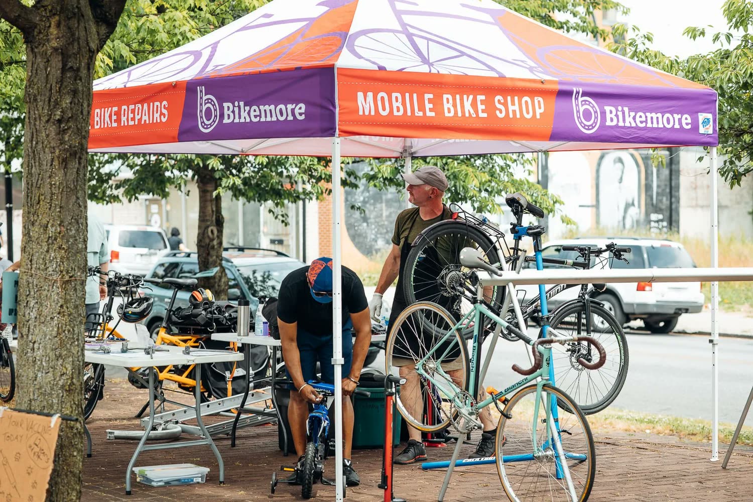 Bikemore's Mobile Bike Shop fixing bikes at a Baltimore block party